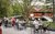 A group of people sitting at tables on an outdoor patio.