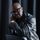 Sunnyboy Dladla A black man in a leather jacket leaning on a chair.
