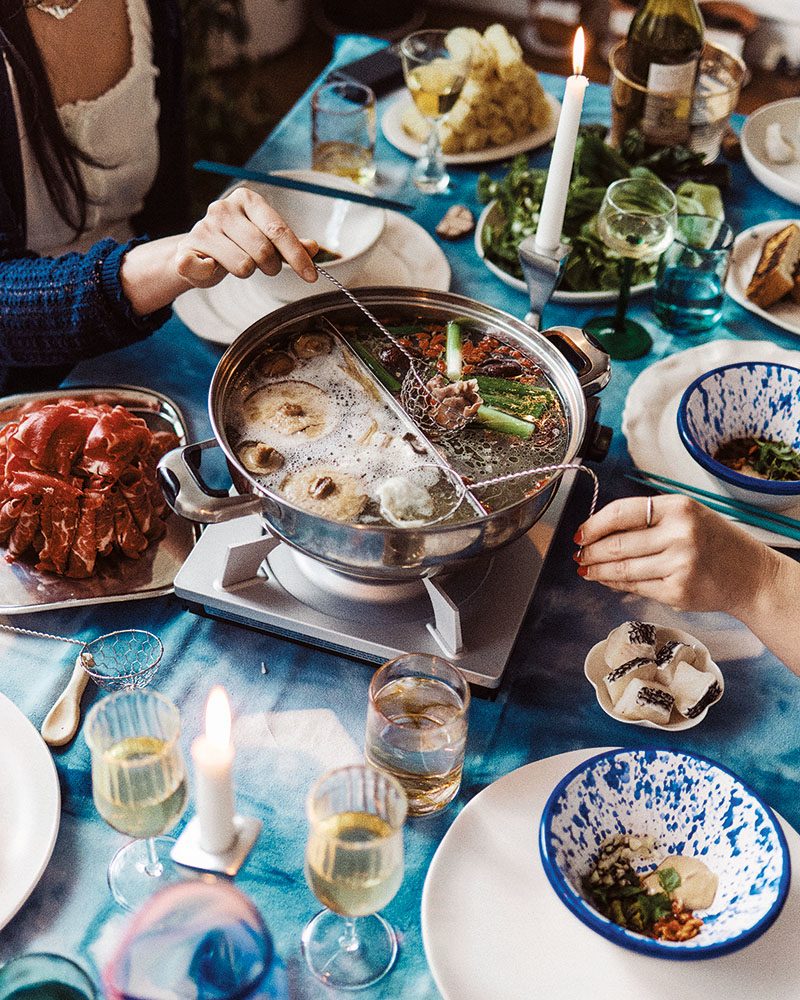 people eating from a hot pot